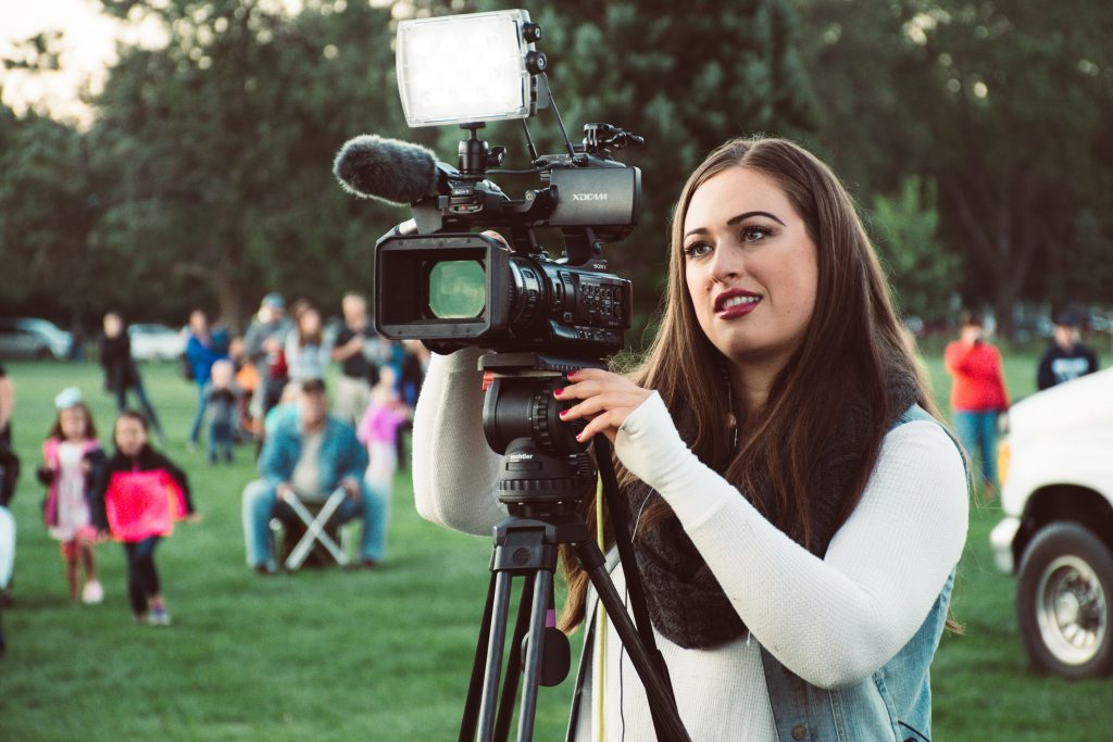 Photo of a woman using a video camera